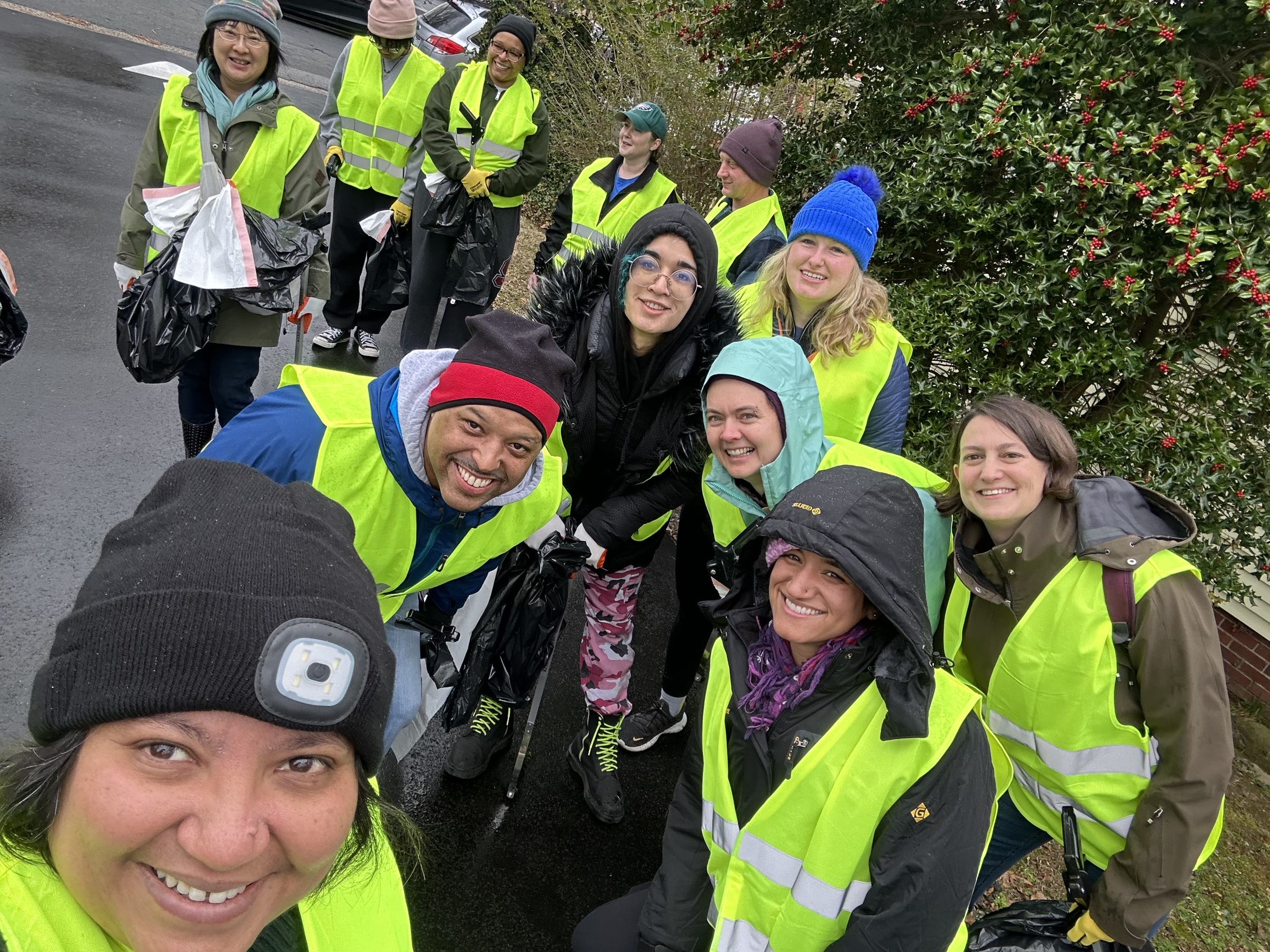 DEI committee volunteers pose for a selfie on the sidewalk during MLK Day 2024