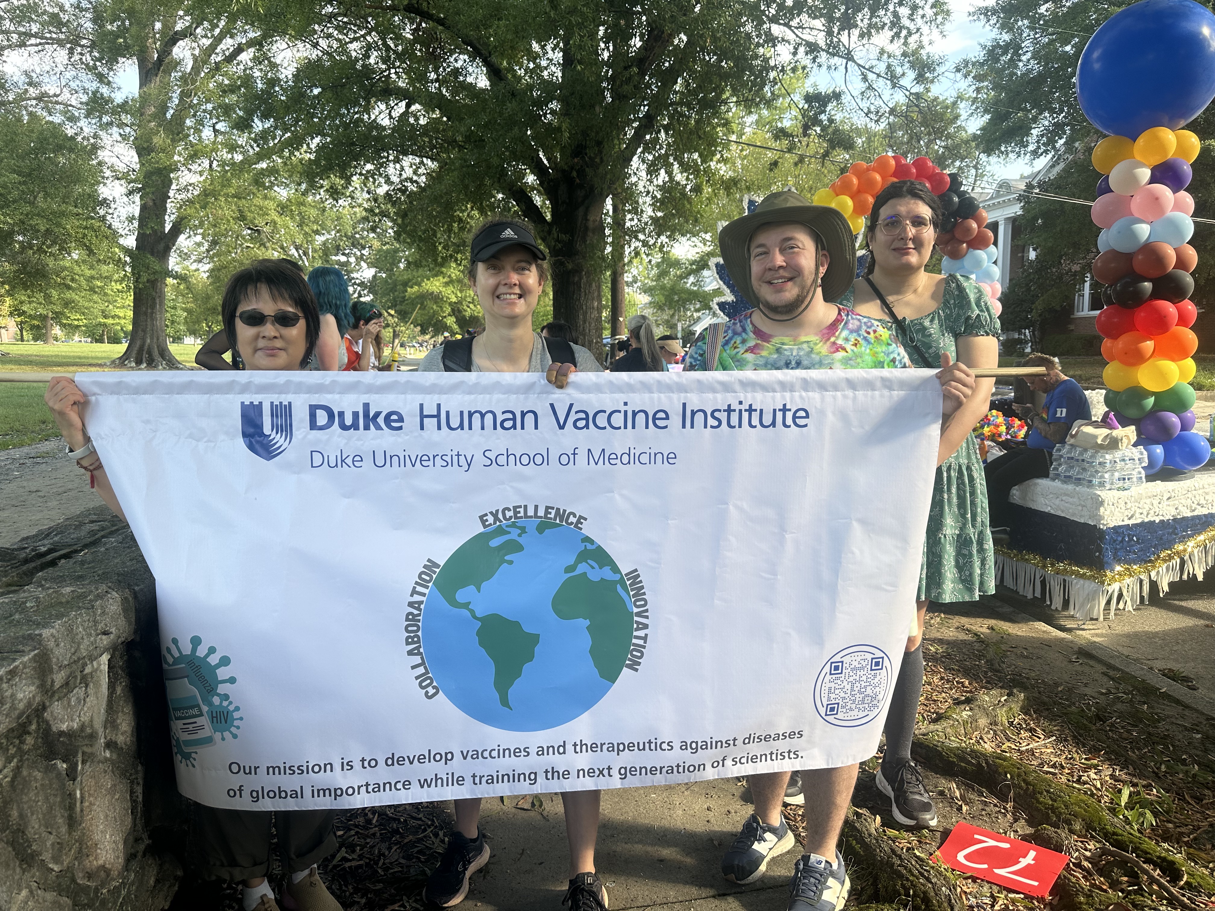 DHVI Pride Parade walkers with banner