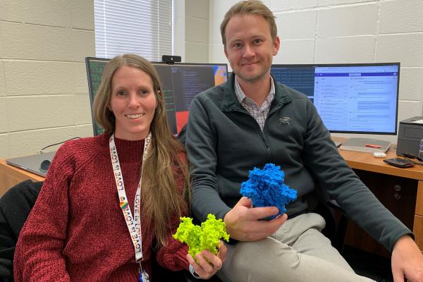 Ashley Bennett and Rory Henderson with 3D printed models of the molecules they study on the HIV virus