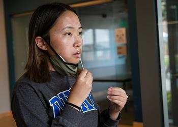 Girl administering covid test on herself