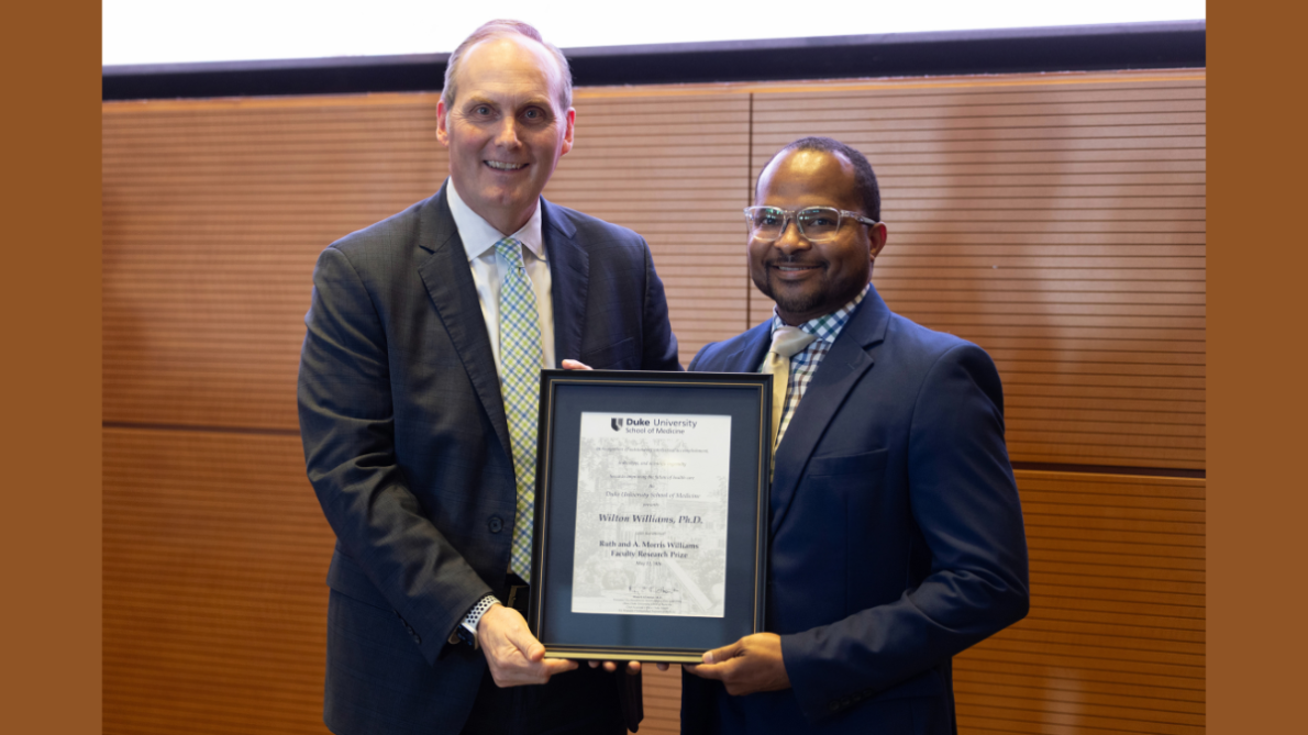 Peter Allen, MD (left) chair of the Department of Surgery, poses with Wilton Williams, PhD, after Williams received his award.