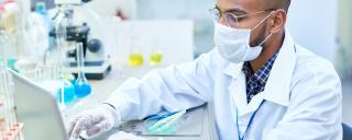 man working in lab wearing a mask